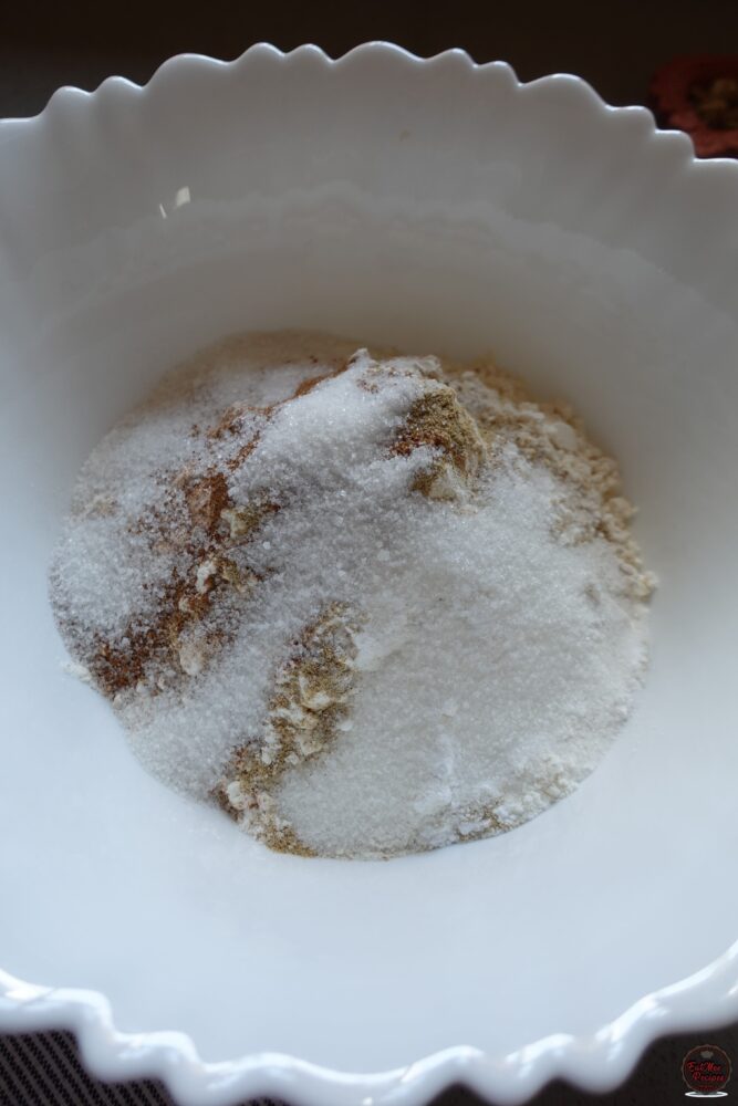 Add all-purpose or cake flour, baking powder, cardamom (elachi) powder, nutmeg powder & granulated sugar to a mixing bowl.