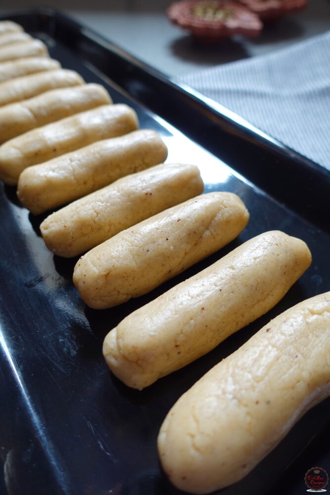 Clench the dough in you palm & the roll into a log using both hands. 