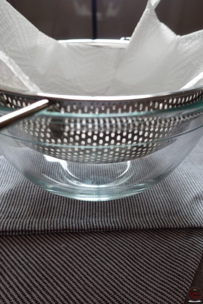 Line a strainer with paper towels & place it over a bowl. This will be used for draining off excess oil.