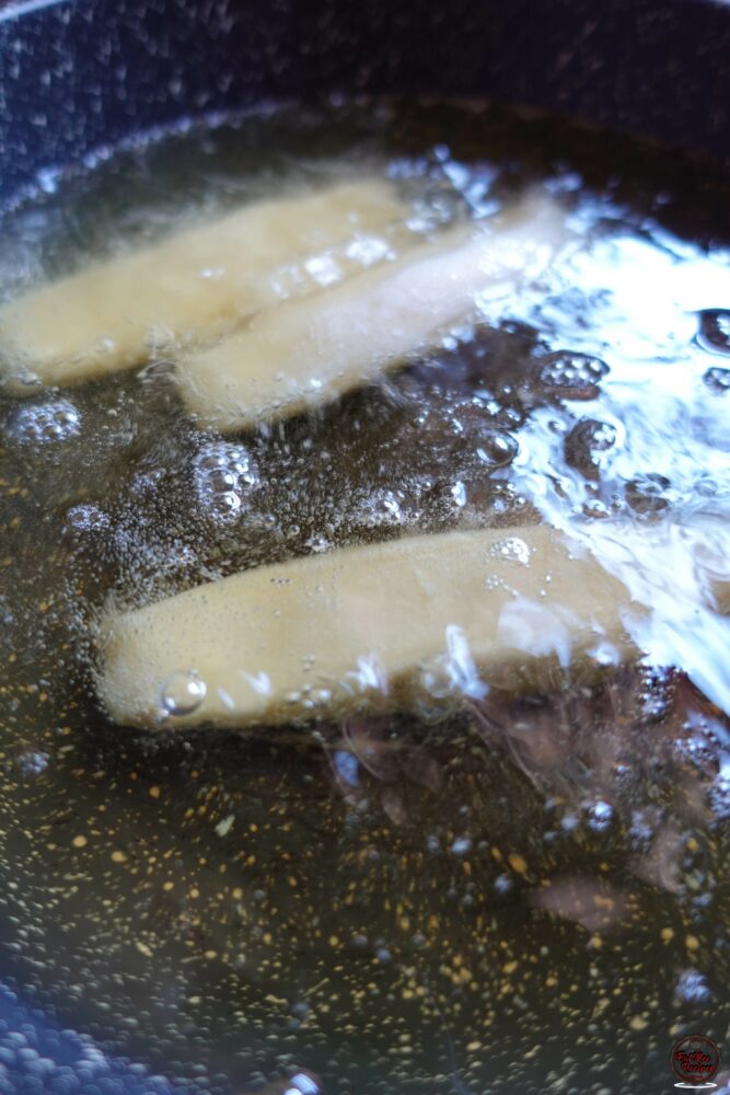 Once the oil is hot, carefully place the flattened puri's in. Only add a few at a time as they will puff up.