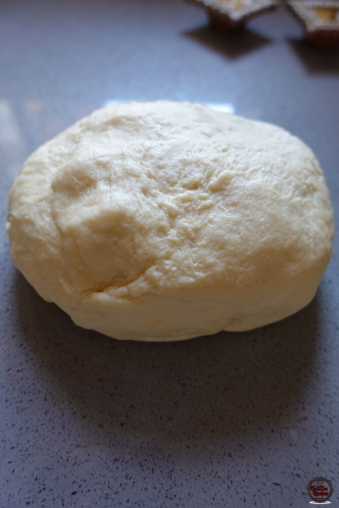 Place the dough onto a working surface & cut into 8 equal parts.